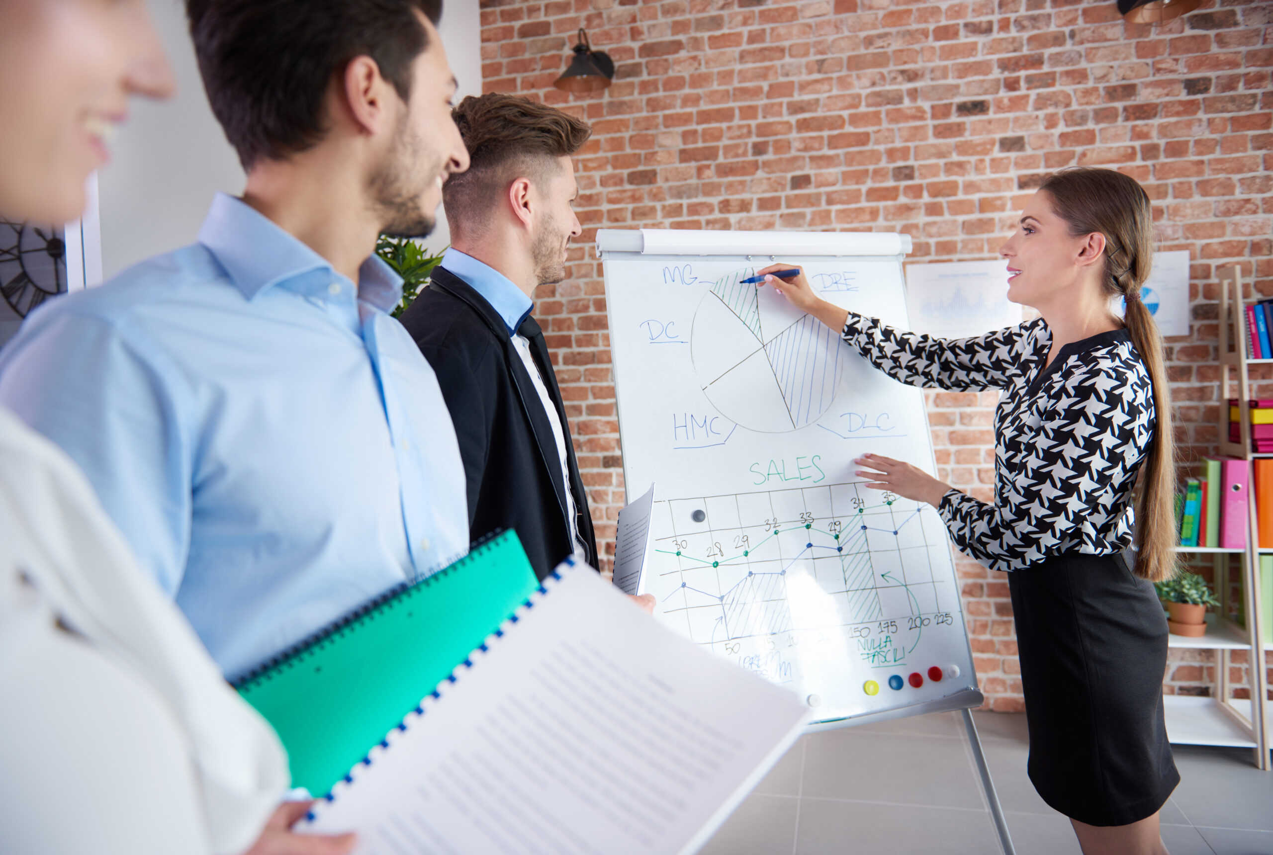 Woman depicting data on the board